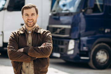 Truck driver standing by his lorry