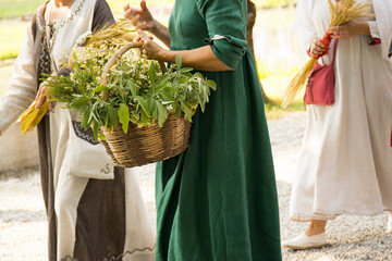 women with basket of grain and flowers