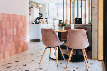 Restaurant interior with empty tables and service counter. Coffee tables over defocused coffee shop...