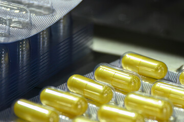 The packaging of the yellow capsule of drugs.