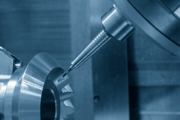 The 5-axis CNC milling machine  cutting the metal gear part.