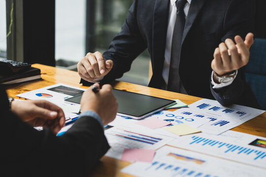 Business people meeting with financial advisors to discuss investment analysis and business strategy planning.