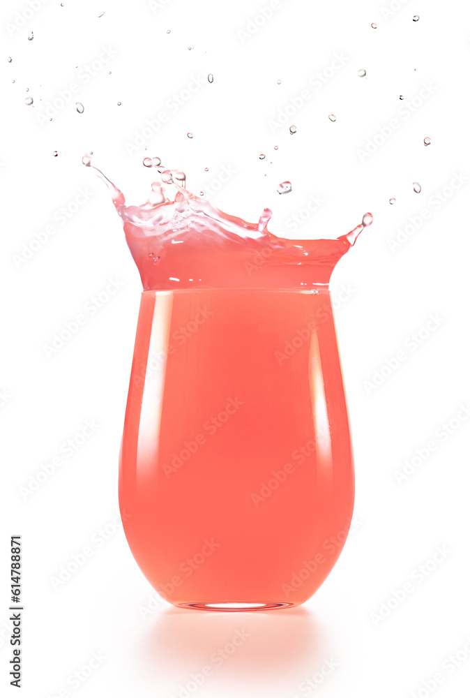 Wall mural pink juice splashing out of overflowing drinking glass isolated on white background. refreshing heal