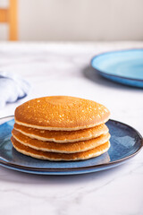 Fresh American Pancakes on blue plate and white background