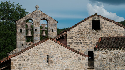 Fototapeta na wymiar Old christian church with bells on a blue sky, south of france