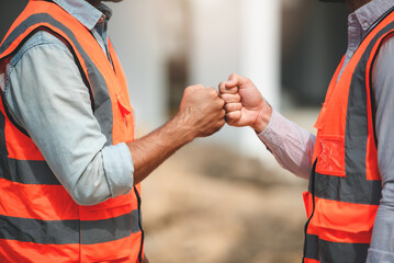 Workers at construction site, young civil engineer working together with teamwork
