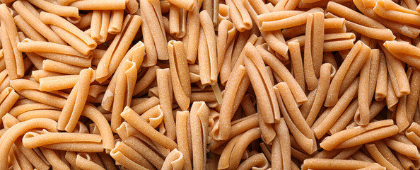 Uncooked pasta as background, closeup