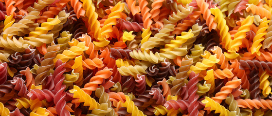 Colorful pasta as background, closeup