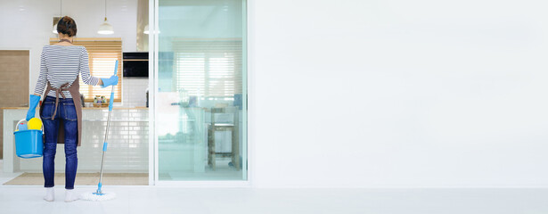 Full length photo of asian ethnicity housewife general cleaning disinfecting all surfaces infection...