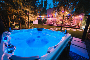 autonomous hot tub or jacuzzi with hot water and evening lighting - obrazy, fototapety, plakaty