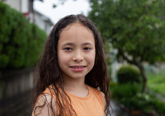 Girl in the rain. Closeup little girl in the summer rain. 