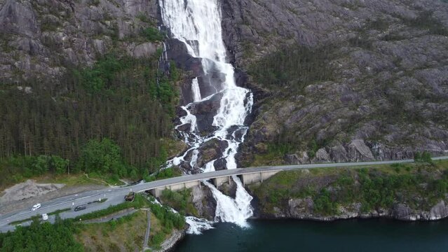 Majestic Langfossen waterfall located in Norway during a moody evening with a bridge