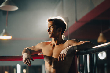 portrait of Asian man boxer having strength body are working out exercise in gym, athlete sportsman fighter male person having strong muscle training active in sport fitness gym for muscular power up