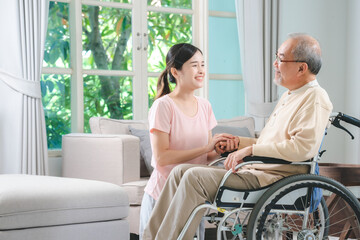 Asian family health care and insurance business at home concept, woman daughter take care support to senior elderly father patient in wheelchair together, dad having smile in happy love lifestyle