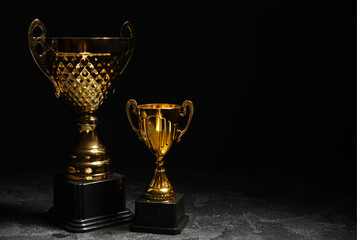 Gold cups on dark background