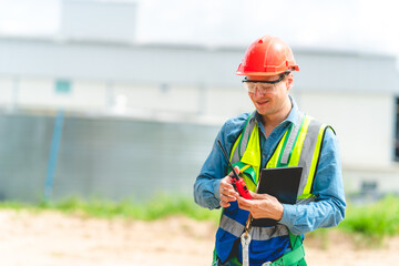 Elegant engineer holding a walkie talkies to working in determined and has a vision like a leader, Discussion and coordination between departments about problem solving, blue collar concept