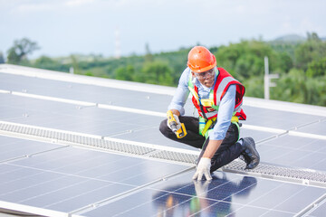 African American engineer maintaining solar cell panels on factory building rooftop. Technician working outdoor on ecological solar farm construction. Renewable clean energy technology concept