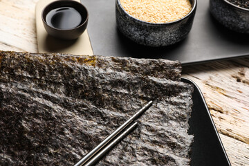 Plate with nori sheets on table, closeup
