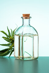  Marijuana leaf and oil in a bottle. Alternative medicine or pharmacy product concept.
