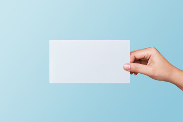 Woman hand holding blank white paper for entering your message. Business and finance concept