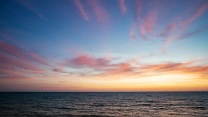 Sunset on the sea in the clouds with sun rays