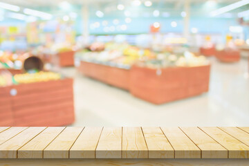 Empty wood table top with supermarket blurred background for product display
