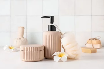 Foto op Canvas Spa composition with soap dispenser, washcloth and plumeria flowers on white table © Pixel-Shot
