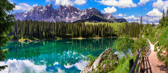 Idyllic nature scenery- trasparent mountain lake Carezza surrounded by Dolomites rocks- one of the most beautiful lakes of Alps. South Tyrol region. Italy - obrazy, fototapety, plakaty