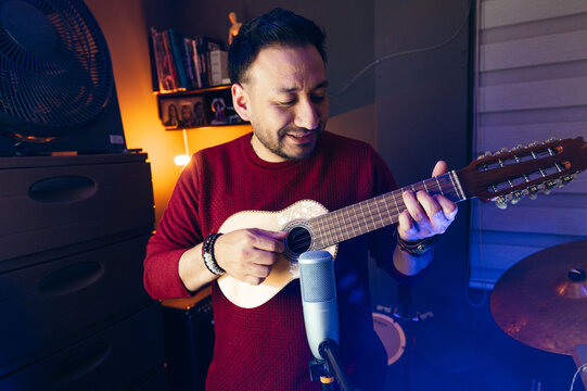 man playing charango in the studio