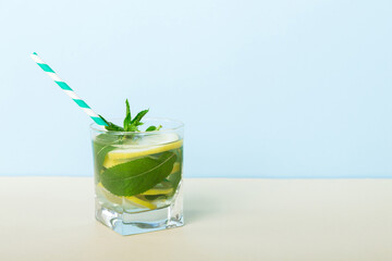 Mojito summer refreshing cocktail with ice and mint. mojito cocktail with lime, lemon and mint in a tall glass with a stick