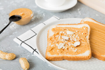 Peanut butter sandwiches or toasts on light table background.Breakfast. Vegetarian food. American cuisine top view vith copy space