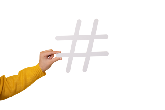 Social media concept, closeup of human hand holding and showing large big white hashtag sign