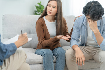 Couple support each while discussing family issues with psychiatrist. wife encourages and empathy husband suffers depression. psychological, divorce, trust, care, workplace and health issues..