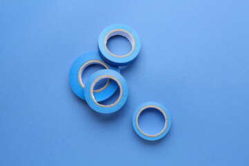Adhesive tape rolls on blue background