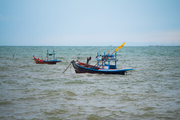 Fototapeta na wymiar Floating fishing boat in the sea