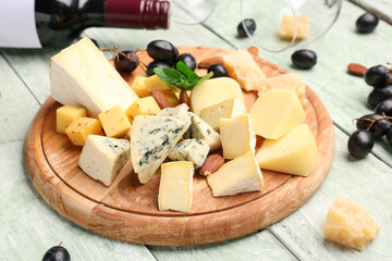 Board with pieces of tasty cheese on light wooden background