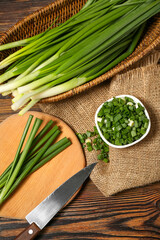 Fresh green onion on wooden background