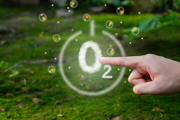 Hand pointing at O2 or oxygen sign. concept of fresh air breathing, purifying process. Nature...