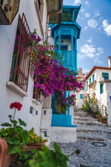 Fototapeta na wymiar Narrow street in old town of Marmaris, Turkey . Beautiful scenic old ancient white houses with flowers. Popular tourist vacation destination