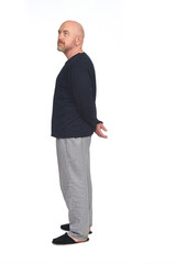 Fototapeta premium side view of a man in pajamas looking away on white background