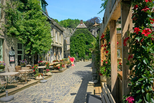 A narrow cobblestone street in Durbuy, the smallest city in Belgium, surrounded by historical stone houses.
