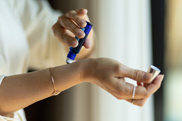 Roller with a fragrance in the hands of a girl, choosing a fragrance for yourself, the concept of...