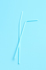 Plastic straws on blue background
