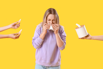 Allergic young woman and female hands holding drops and tissue box on yellow background
