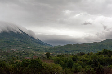 Obraz na płótnie Canvas Ccouds leaning against the Taburno mountaintop. Campanian Apennines, Sant'Agata de' Goti area, municipality in the Benevento region, Italy.