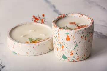 Holders with candles on white background