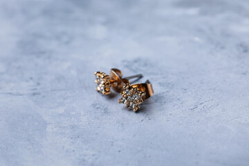 Beautiful earrings on blue background