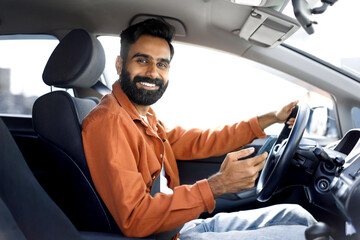 Happy Indian Driver Man Using Mobile Phone Sitting In Automobile
