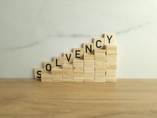 Wooden stairs up with word solvency. Creditworthiness, banking conditions, credit funds