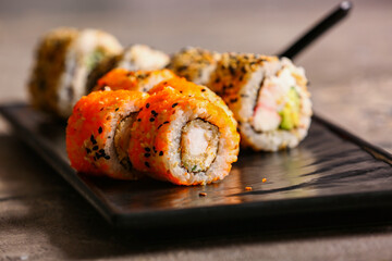 Plate with tasty sushi rolls on  table, closeup